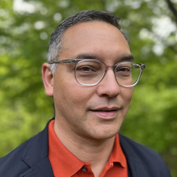 2022 AIGA Medalist Andrew Satake Blauvelt. Image courtesy of Andrew Satake Blauvelt Headshot of 2022 AIGA Medalist Andrew Satake Blauvelt wearing a collar shirt and jacket and glasses against an outdoor setting. Image courtesy of Andrew Satake Blauvelt.