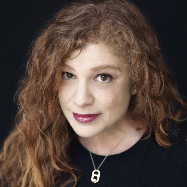 2022 AIGA Medalist Emily Oberman. Image courtesy of Pentagram. Photo credit: © Jake Chessum Headshot of 2022 AIGA Medalist Emily Oberman wearing a black top with a necklace against a black background. Image courtesy of Pentagram. Photo credit: ©: Jake Chessum